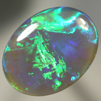SOLID SEMI BLACK OPAL Large opal with rolling flashes of neon fire. SEE VIDEO
